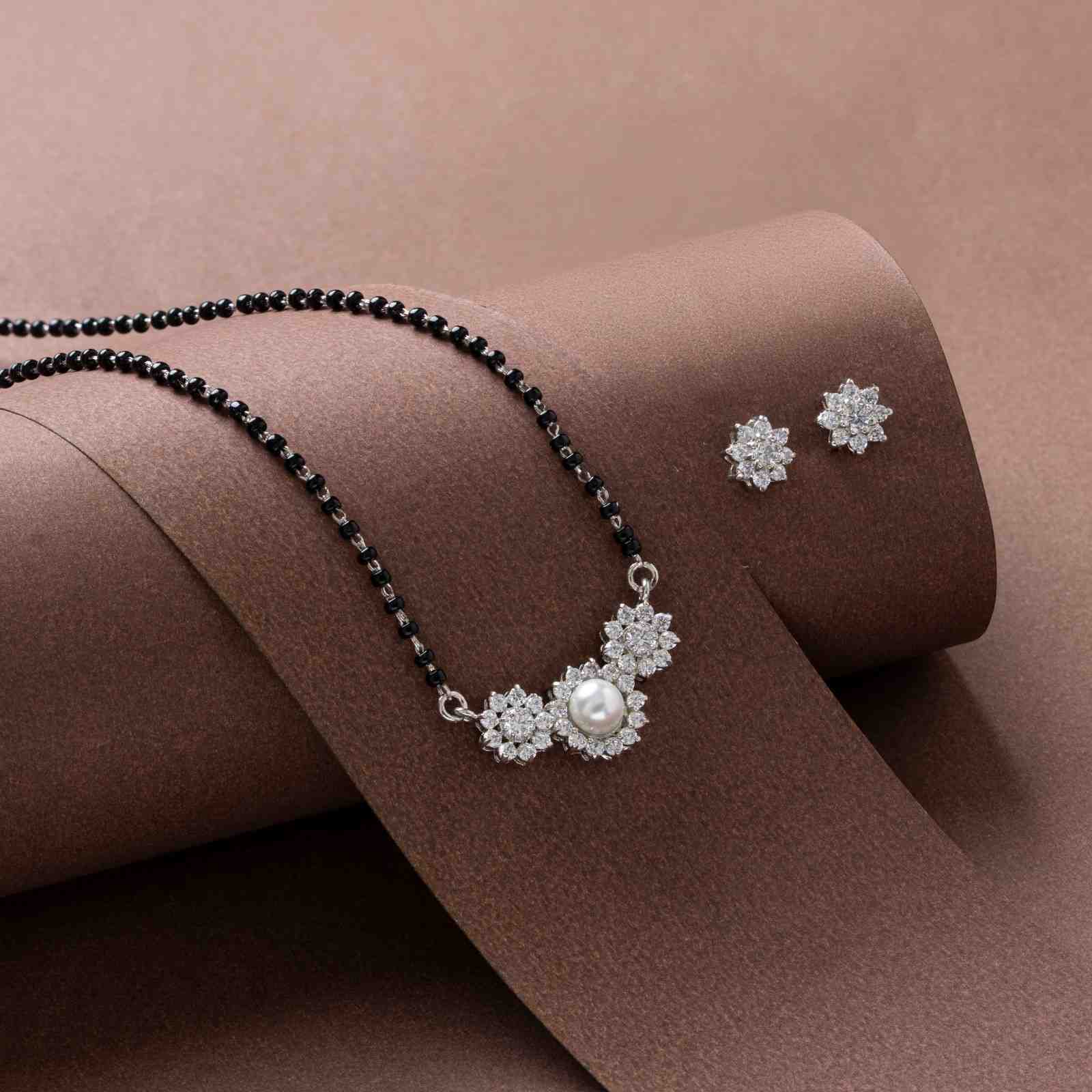 A beautiful 925 silver jewelry set consisting of a mangalsutra-style necklace and a pair of stud earrings.